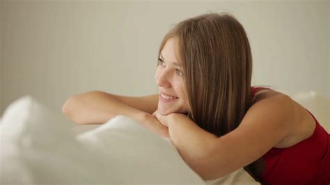 Beautiful Girl Relaxing On Couch Smiling At Camera Stock Video Footage