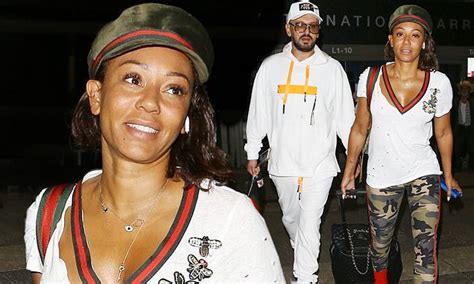 mel b arrives at lax in ripped tee and camo pants with bff gary madatyan after quick trip to uk