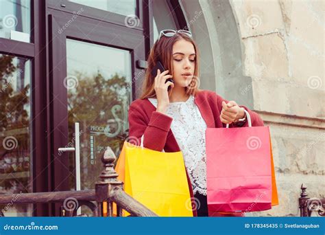 Busy Life Woman With Shopping Bags Talking At Phone Coming Out From