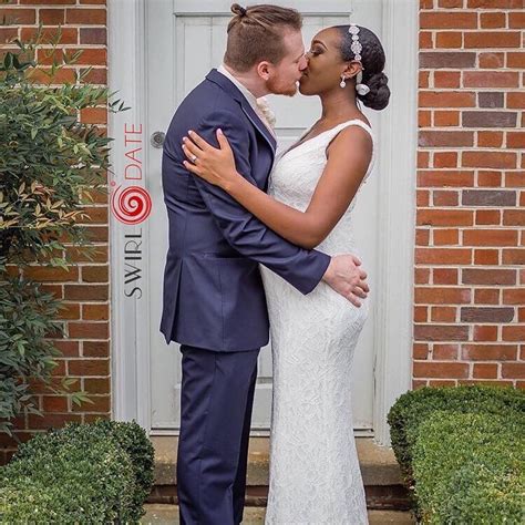gorgeous interracial couple holding onto each other tightly after becoming husband and wife