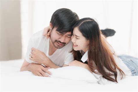 Beautiful Asian Couple In Love And Smiling Sitting On Bed Romantic Moment Relationships