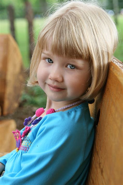 Blond Preschool Girl On Bench