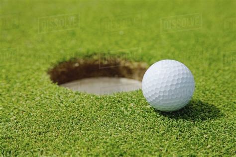 Golf Ball Near A Hole Stock Photo Dissolve