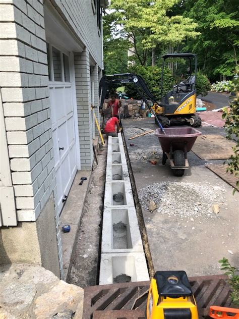 The water is spreading as it flows downward. Stamford, CT - Driveway Drainage - Trench Drain Systems ...