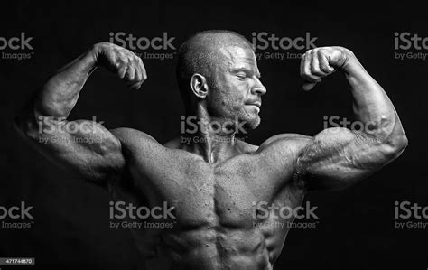 The Muscular Male Bodybuilder Flexing Biceps Stock Photo Download
