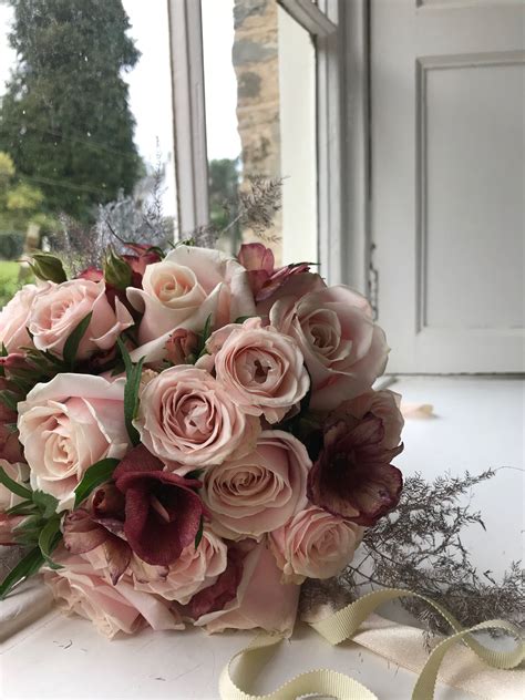 Make the bouquet the day before the wedding, wrap the stems with ribbon and secure it with corsage pins. Blush pink rose bouquet with burgundy ranunculus and ...
