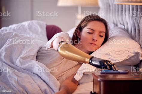 Couple With Woman With Prosthetic Arm Sleeping In Bed Before Being