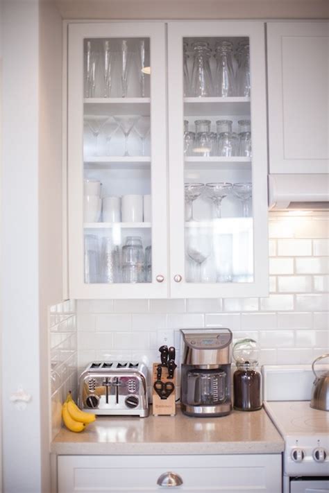 A series of pitchers filled with faux flowers is also an ideal way to fill the void. Glass Front Kitchen Cabinets - Transitional - kitchen ...