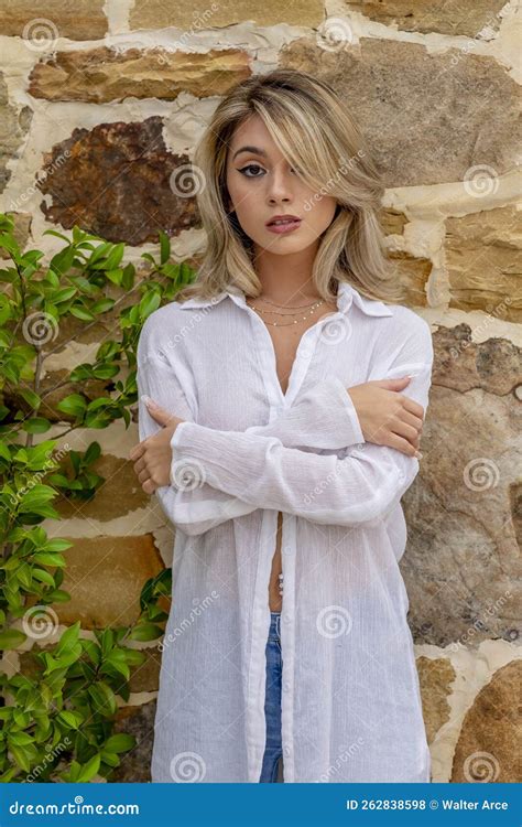 A Lovely Blonde Model Poses Outdoor While Enjoying The Spring Weather