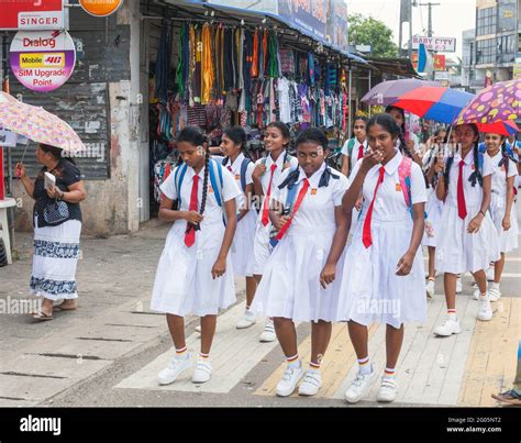 Sri Lankan Schoolgirls In White School Uniform Walk Through Town After