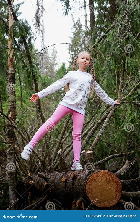 Young Cute Blonde Girl Playing And Having Fun On Walk In Forest