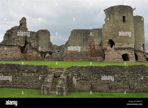 The Ruins Of Rhuddlan Castle Seen Against A Brooding Gray Sky From