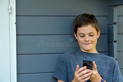 Teenage Boy Using A Cellphone Stock Photo Image Of Cute Expression