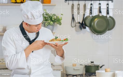 Portrait Handsome Asian Professional Male Chef Wearing White Uniform Hat Holding Showing Plate