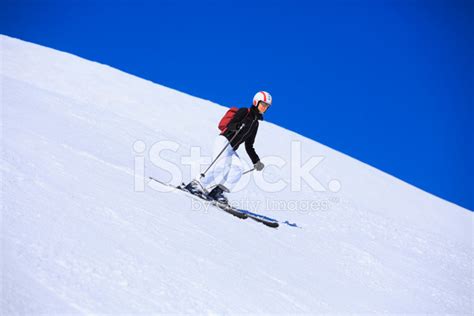 Mid Adult Women Snow Skier Skiing On Sunny Ski Resorts Stock Photo