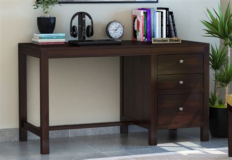 The open space on the top provides an ample room for a person to work conveniently and the foot rest at the bottom makes long working hours easy and comfortable.this teak wood study table is a must have for your study room and will definitely be a piece of attraction for everybody. Buy Slater Study Table With Drawer (Walnut Finish) Online ...