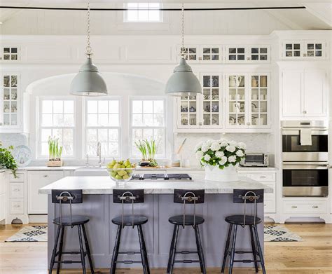 An aesthetic large trendy kitchen island of wooden materials finished in white. 15 Gorgeous White Kitchens with Coloured Islands - The Happy Housie