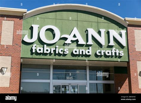 A Logo Sign Outside Of A Jo Ann Fabrics And Crafts Retail Store