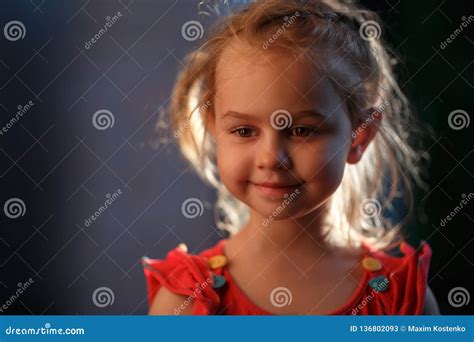 Portrait Of A Charming Fair Haired Girl Standing Outside On A Warm Summer Evening The Sun