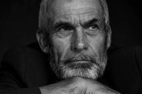 close up portrait of handsome mature man with beard monochrome indoor