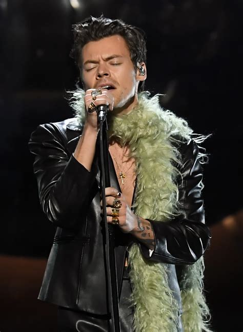 harry kicked off the night in a leather suit a green boa and that harry styles wore an nsfw