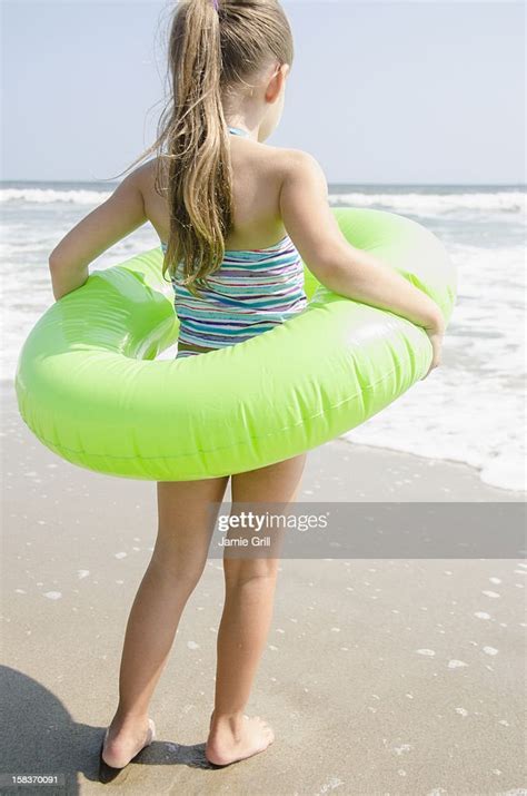 Young Girl Wearing Inner Tube At Beach Photo Getty Images