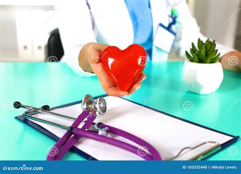 Woman Doctor With A Stethoscope Holds A Heart Stock Photo Image Of