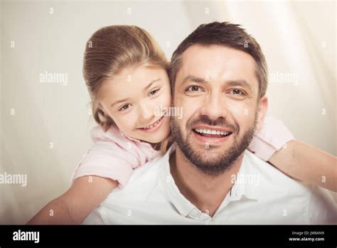 Close Up Portrait Of Happy Father And Daughter Hugging And Smiling At