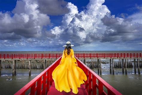 Asian Women Wear Yellow Dresses Walking On Red Wooden Bridges Red