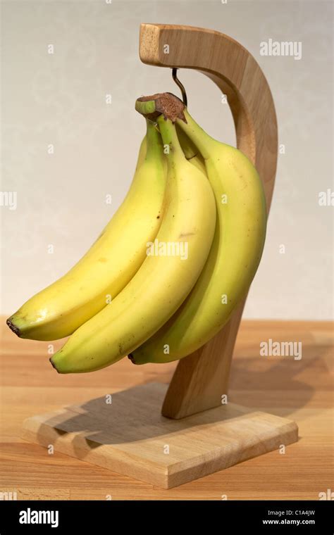 Ripening Bananas Hanging From A Wooden Banana Hanger Stock Photo Alamy