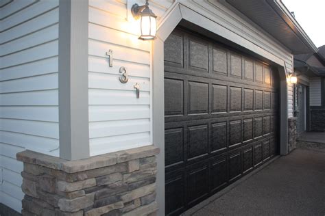 If your garage doors are smoother, you could always spray them if you are worried about the roller giving it a texture. She Re-Purposed It: How to paint your garage & front door!