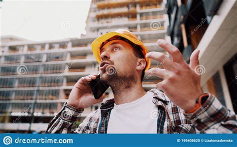 Angry Male Architect In Orange Hard Hat Talks Swears On Phone At