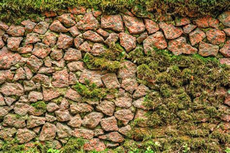 Ancient Rough Cobble Stone Wall With Moss Textured Granite Rocks