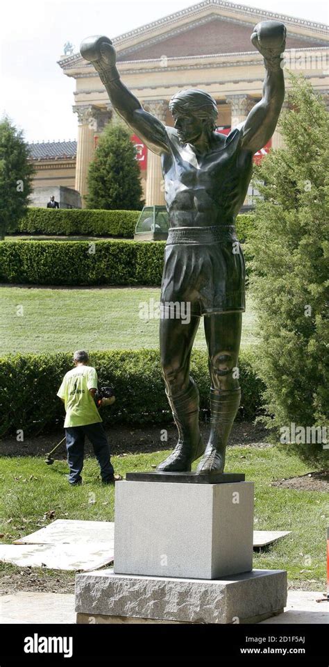 A Landscaper Works Behind The Rocky Statue Near The Philadelphia