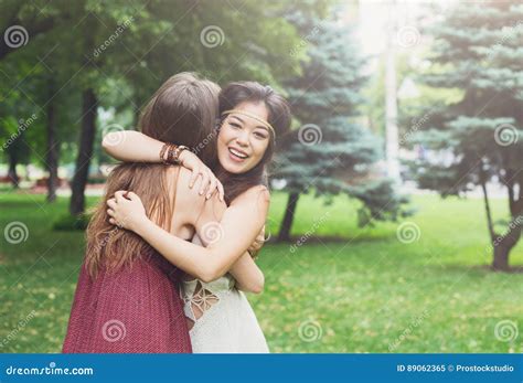Two Happy Young Girls Hug Each Other In Summer Park Stock Image Image