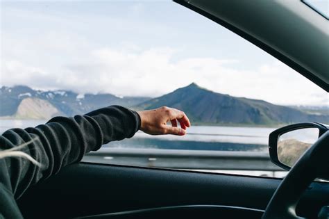 Free Photo Man Hold Out Hand When Driving Car