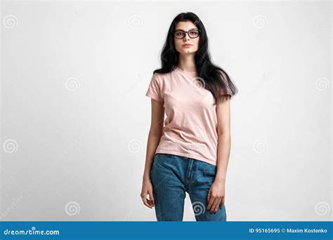 Portrait Of Smart Beautiful Brunette Girl In Eyeglasses With Natural Make Up On Grey Background