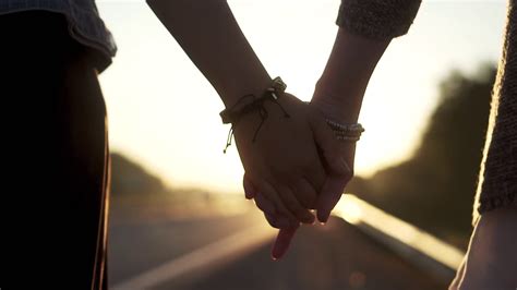 Girlfriend And Boyfriend Holding Hands Sunset