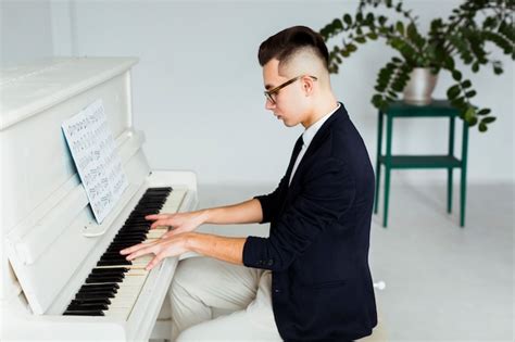Side View Of A Young Man Playing Grand Piano Free Photo