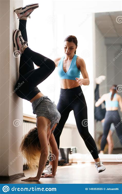Trainer Helping Sporty Woman To Do Handstand Stock Image Image Of