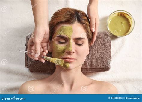 Cosmetologist Applying Mask Onto Woman`s Face In Spa Salon Stock Image Image Of Facial