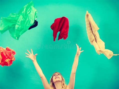 Woman Throwing Up Clothes Clothing Flying Everywhere Stock Image