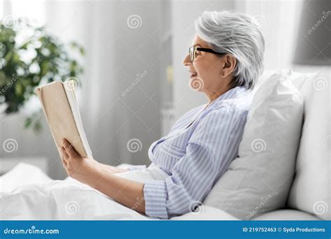 Old Woman In Glasses Reading Book In Bed At Home Stock Image Image Of
