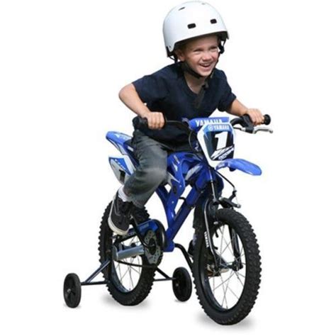 A Young Boy Riding On The Back Of A Blue Dirt Bike