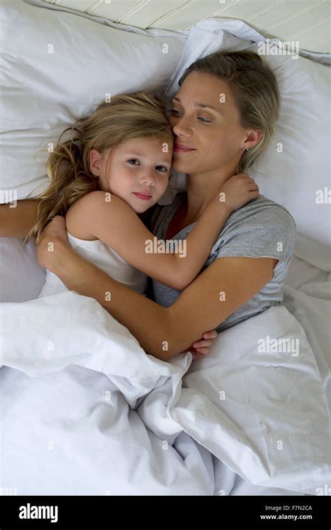 Mother And Daughter In Bed Embracing Stock Photo Alamy