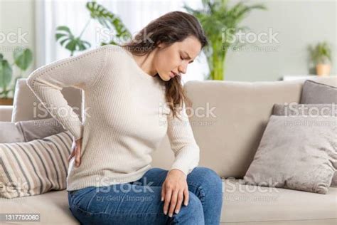 Young Woman Suffering With Back Pain Stock Photo Download Image Now