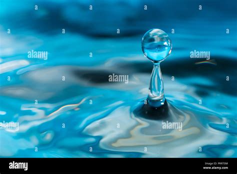 Colorful Water Droplet Bouncing On Water Stock Photo Alamy