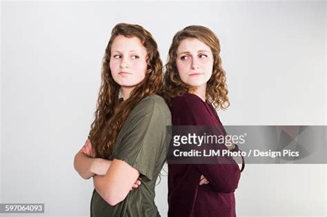 Studio Shot Of Two Girlfriends Fighting On A White Background High Res