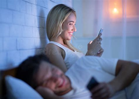 Couple Texting On Phone Lying In Bed At Night Stock Image Image Of Husband Concept 163840137
