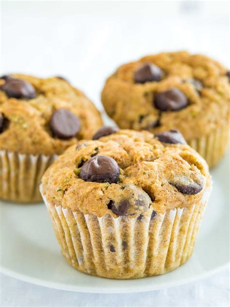 Three Chocolate Chip Muffins On A White Plate
